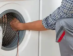 Dryer repair technician diagnosing and servicing a clothes dryer in Portland, OR