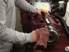 Vacuum repair technician cleaning and servicing a vacuum motor in Portland, OR