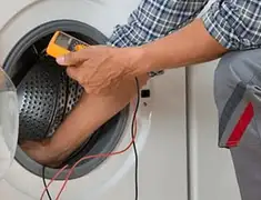 Washing machine repair technician testing a front-load washer with diagnostic tools in Portland, OR